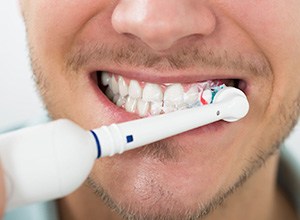 man brushing teeth