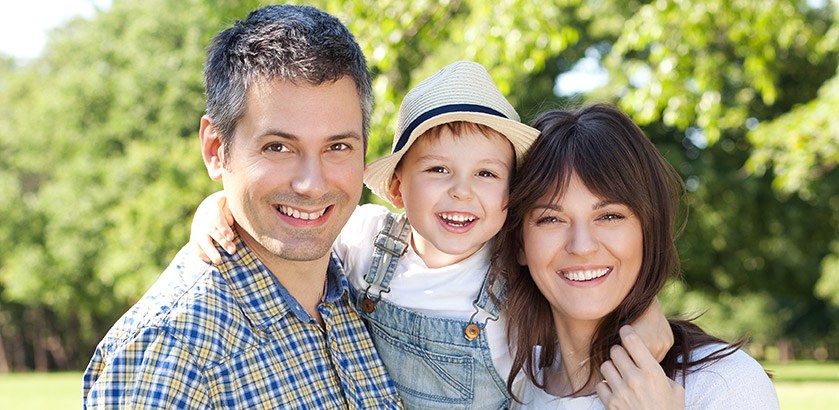 Happy family of three smiling