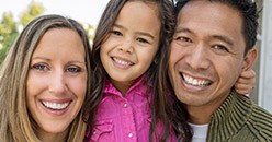 Family smiling with perfect teeth