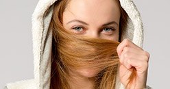 Young woman covering her mouth with her hair