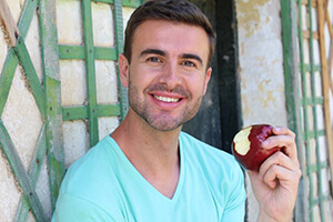 Man eating apple