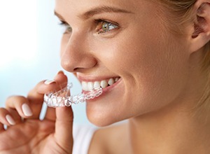 Fairfield woman putting on Invisalign clear braces