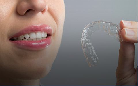 Patient inserting Invisalign tray