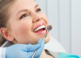 woman receiving dental screening smiling
